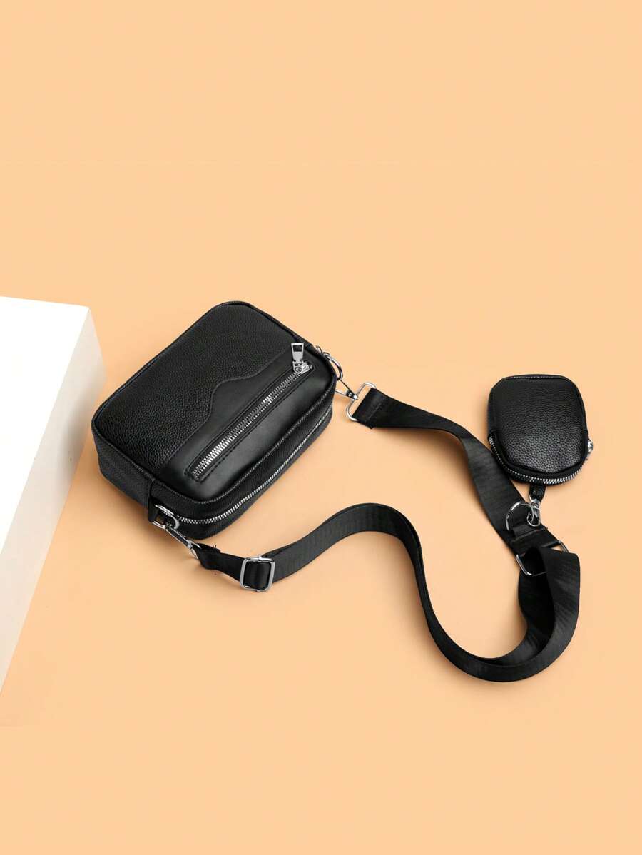sacoche noir uni posee sur sol avec mini sacoche sur sangle
